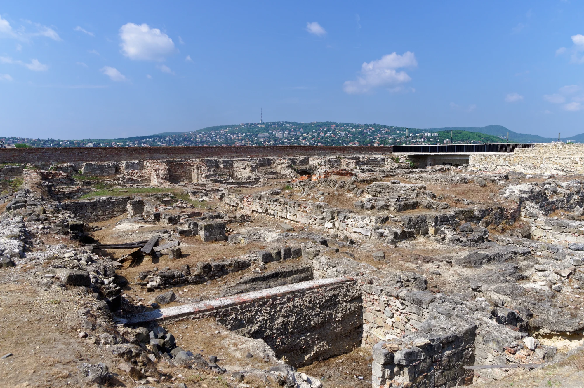 Archaeological ruins in Budapest’s Castle District with Buda Hills beyond.