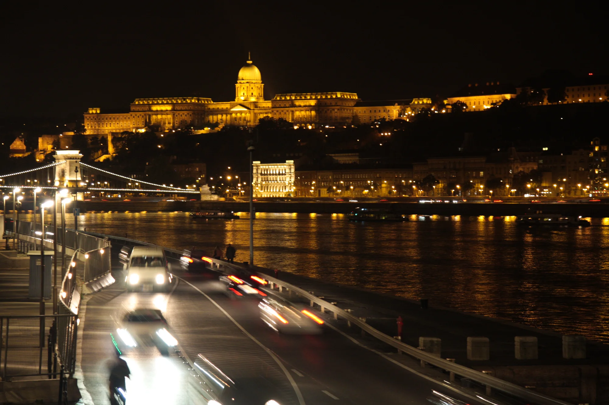 Buda Castle and the Chain Bridge glowing over the Danube at night